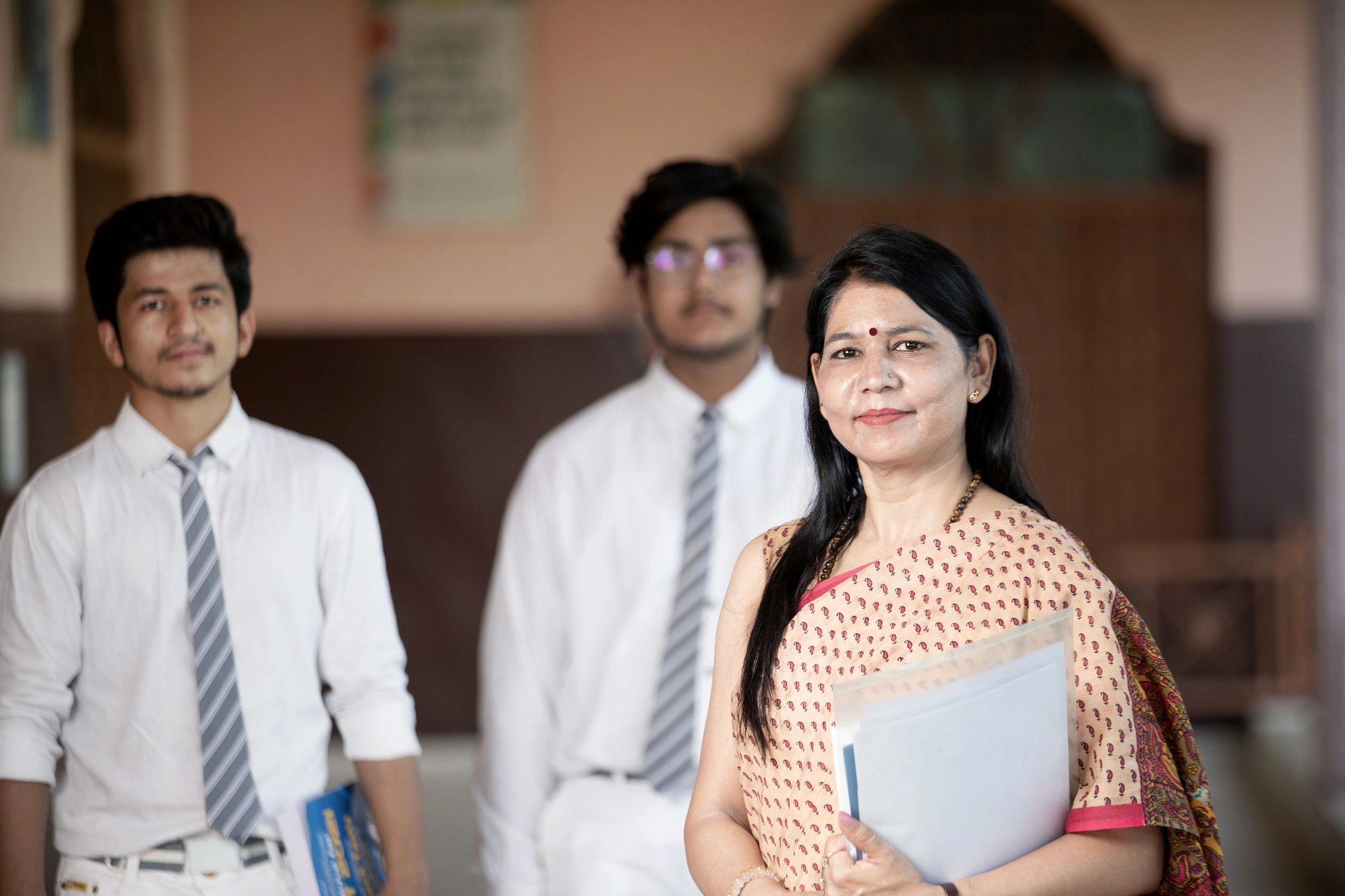 Educator with students representing trusted academic support